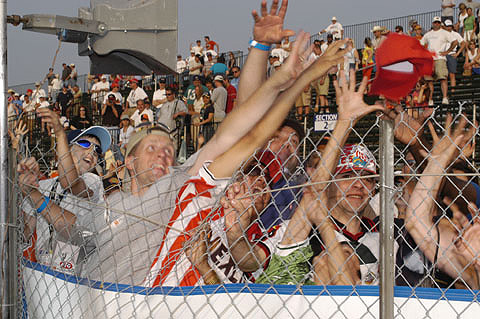 Fans Reach For Thrown Hat