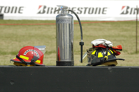 Fire Helmets and Extinguisher On Pit Wall