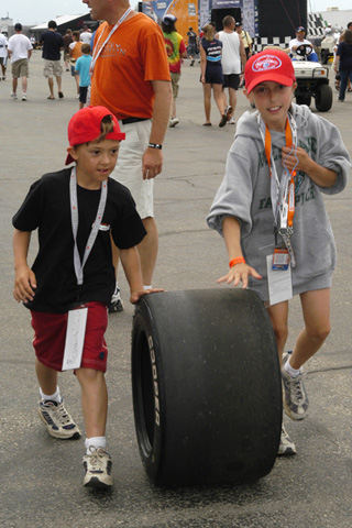 Two Young Fans Rolling Tire