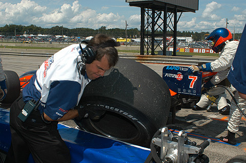 Lifting Tire Over Pit Wall